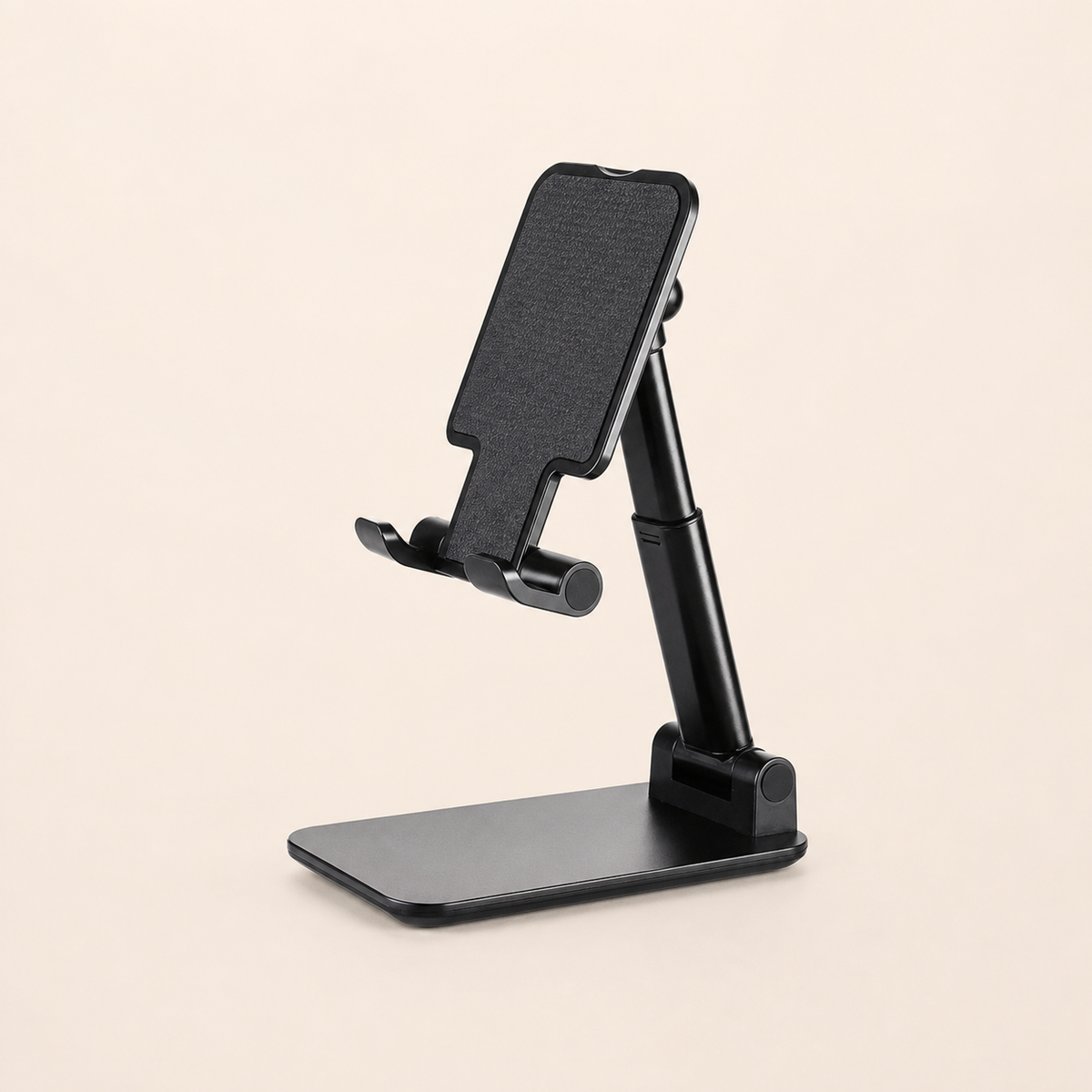 Black adjustable desktop phone and tablet stand on a warm off-white background