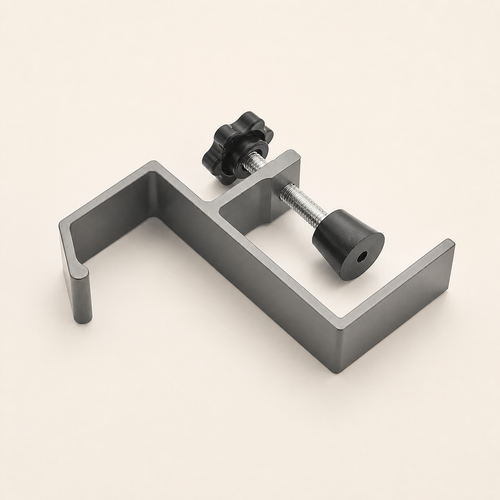 Gray aluminum desk-edge hook with screw clamp on a warm off-white background