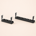 Fixed and retractable black clamp-on under-desk cable trays on a square off-white background