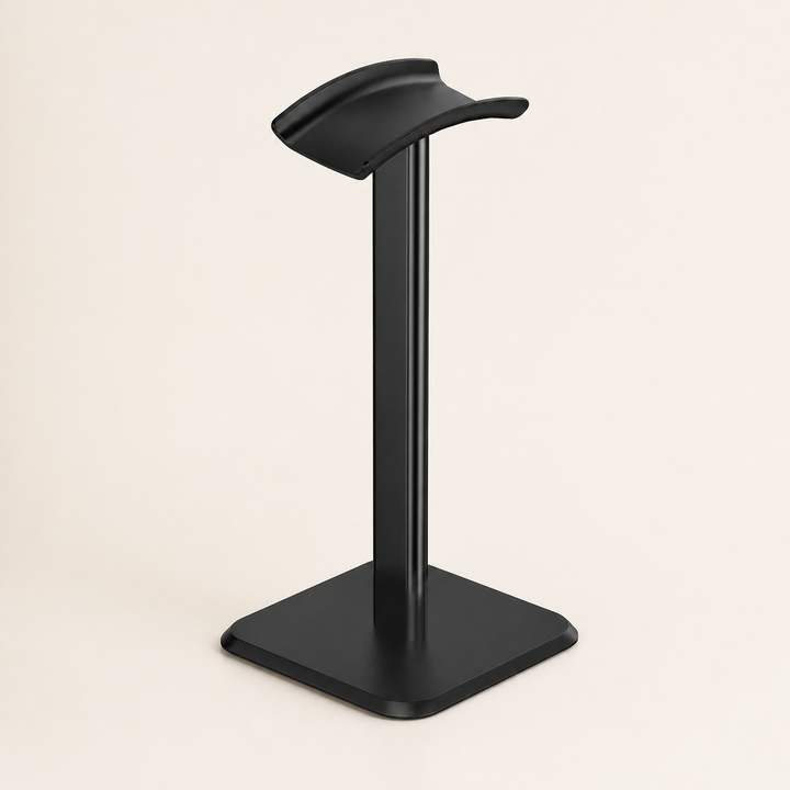 Black desktop headphone stand on a warm off-white background