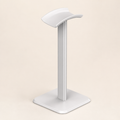 White desktop headphone stand on a warm off-white background