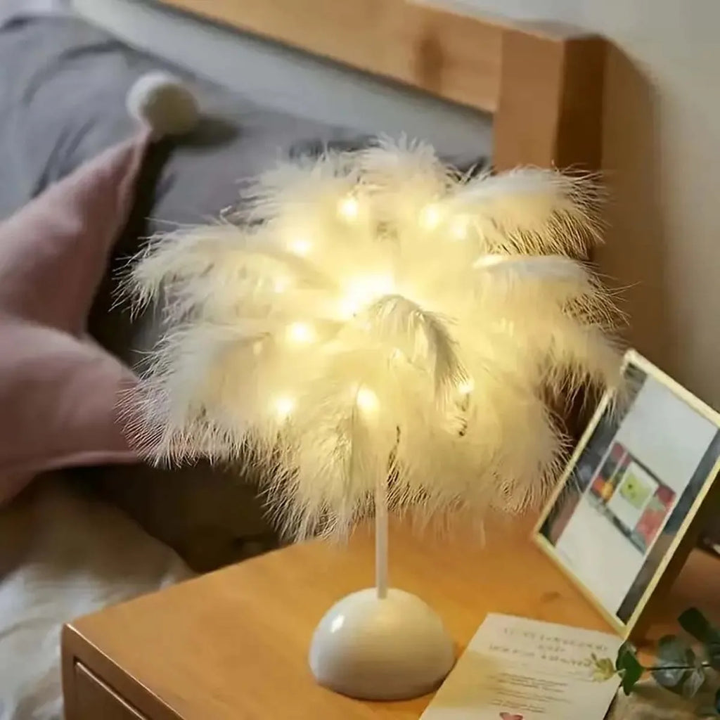 White feather LED lamp glowing on a wooden bedside table