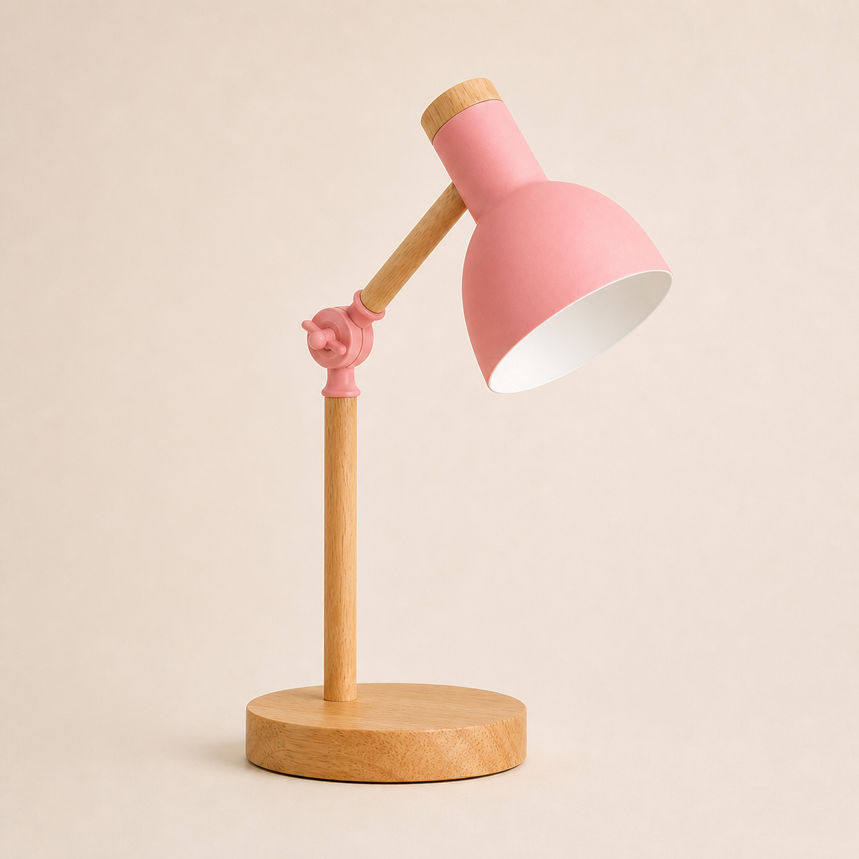 Pink wood turn-head table lamp on a square off-white studio background