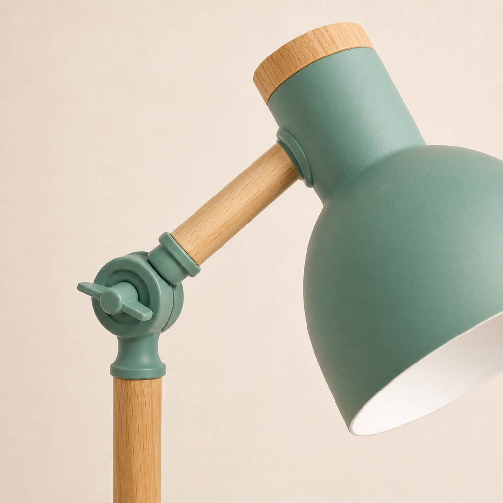 Close view of the green lamp pivot joint, wood arm, and metal shade